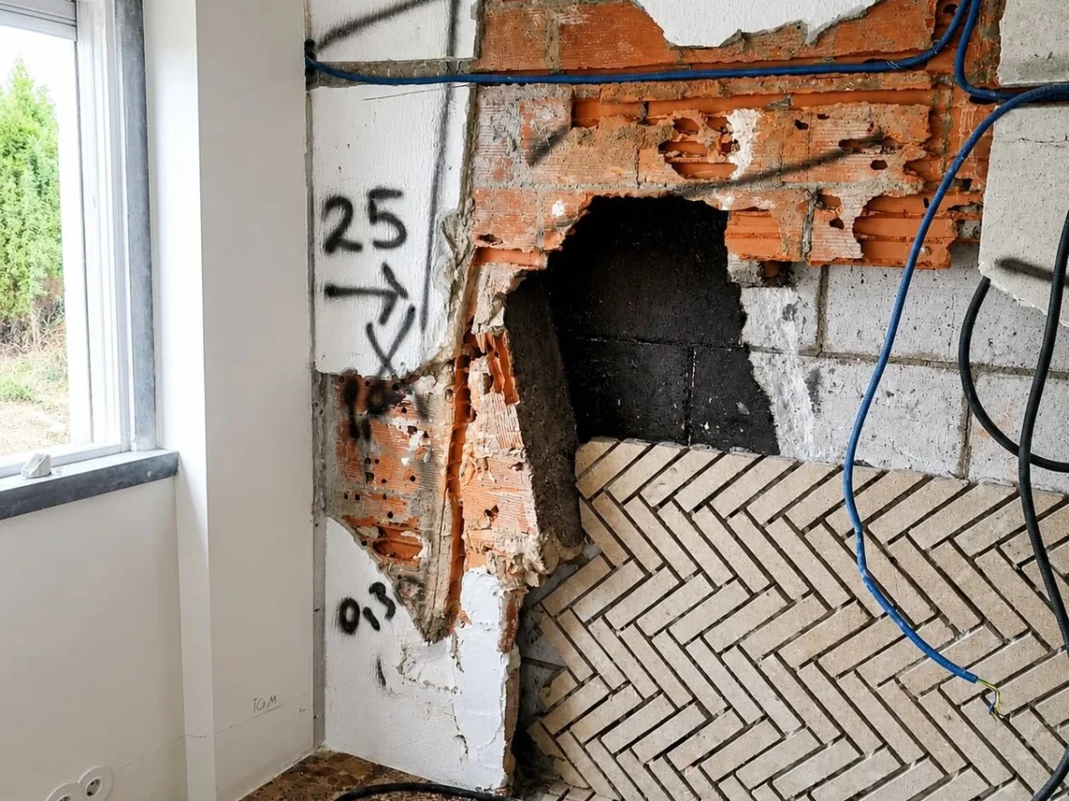 Before — opening formed in a masonry wall for a wood-burning insert