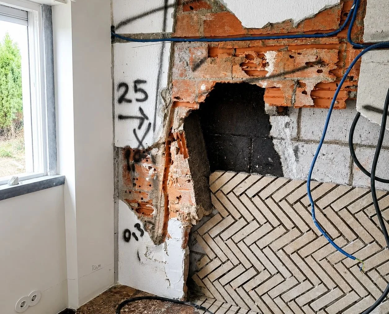 Before — opening formed in a masonry wall for a wood-burning insert