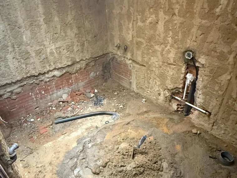 Before — bathroom stripped out for new pipework and finishes