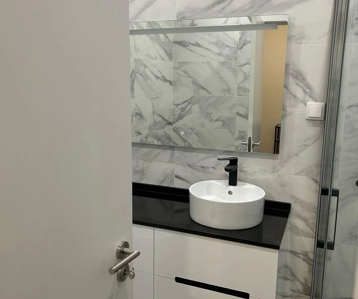 Marble bathroom with a wall-hung unit and a stone top