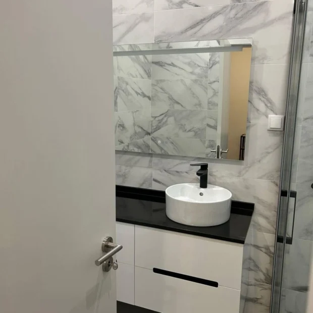 Marble bathroom with a wall-hung unit and a stone top