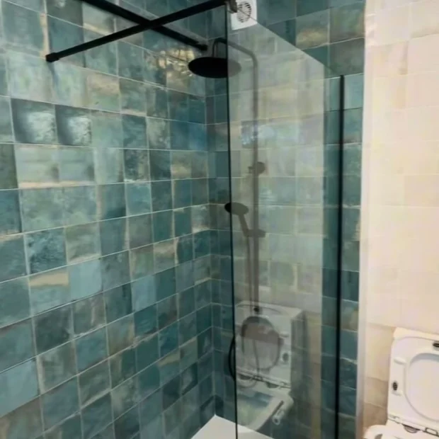 Shower lined in zellige tile, with matt black fittings