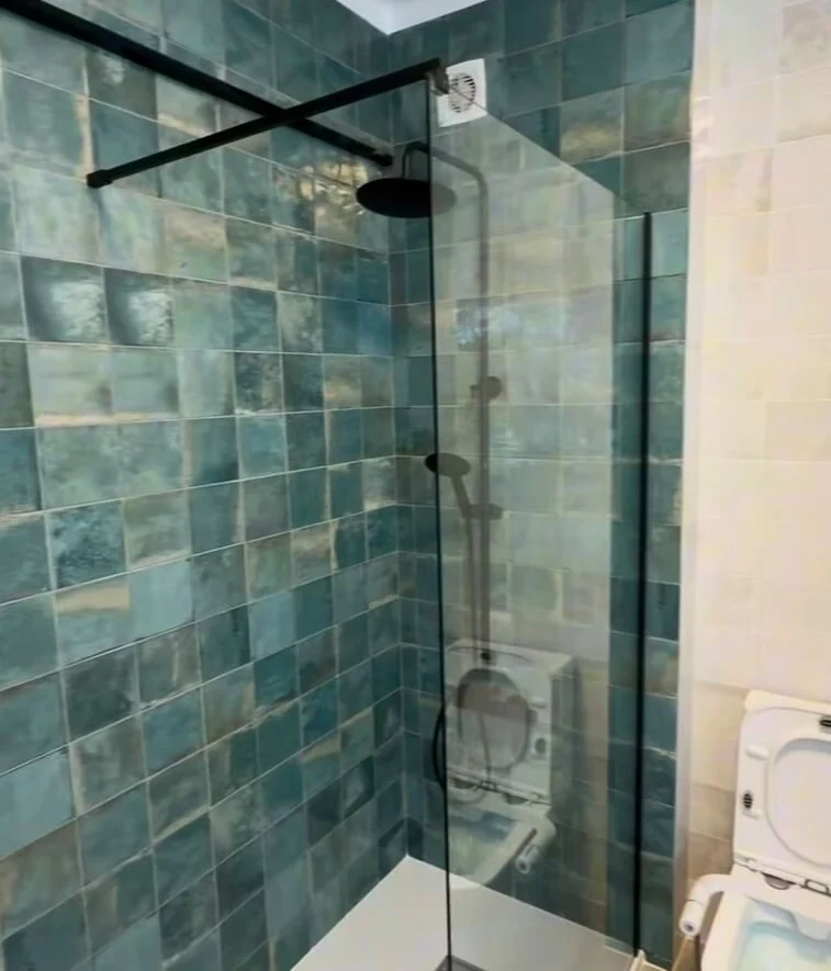 Shower lined in zellige tile, with matt black fittings