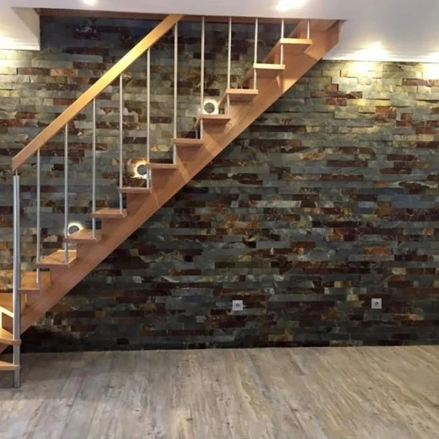 After — timber stair against a wall clad in natural stone
