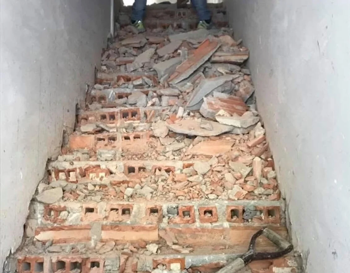 Before — stair stripped back to the masonry