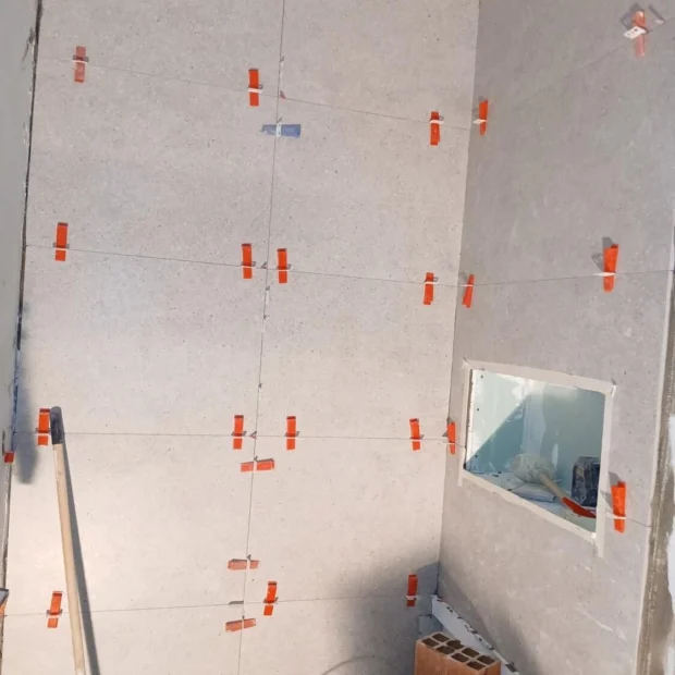 Laying tile with spacers and levelling clips