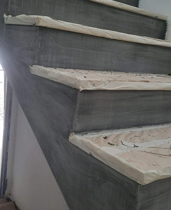 Stair with dark microcement risers and timber treads