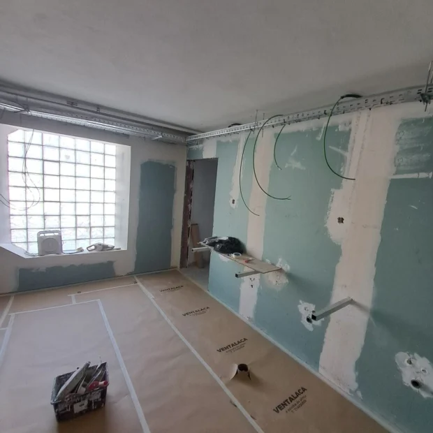 Walls prepared and the floor protected before application