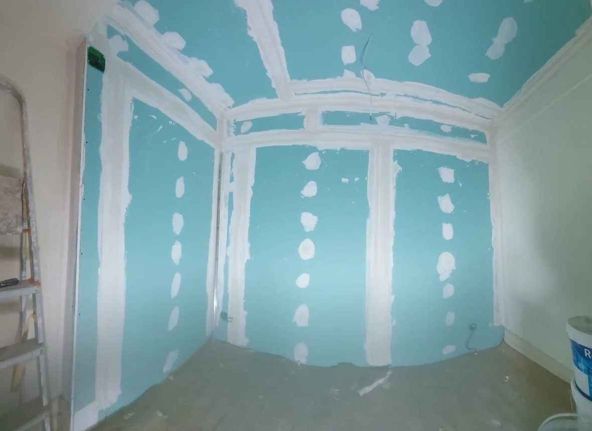 Partition in moisture-resistant board, joints taped