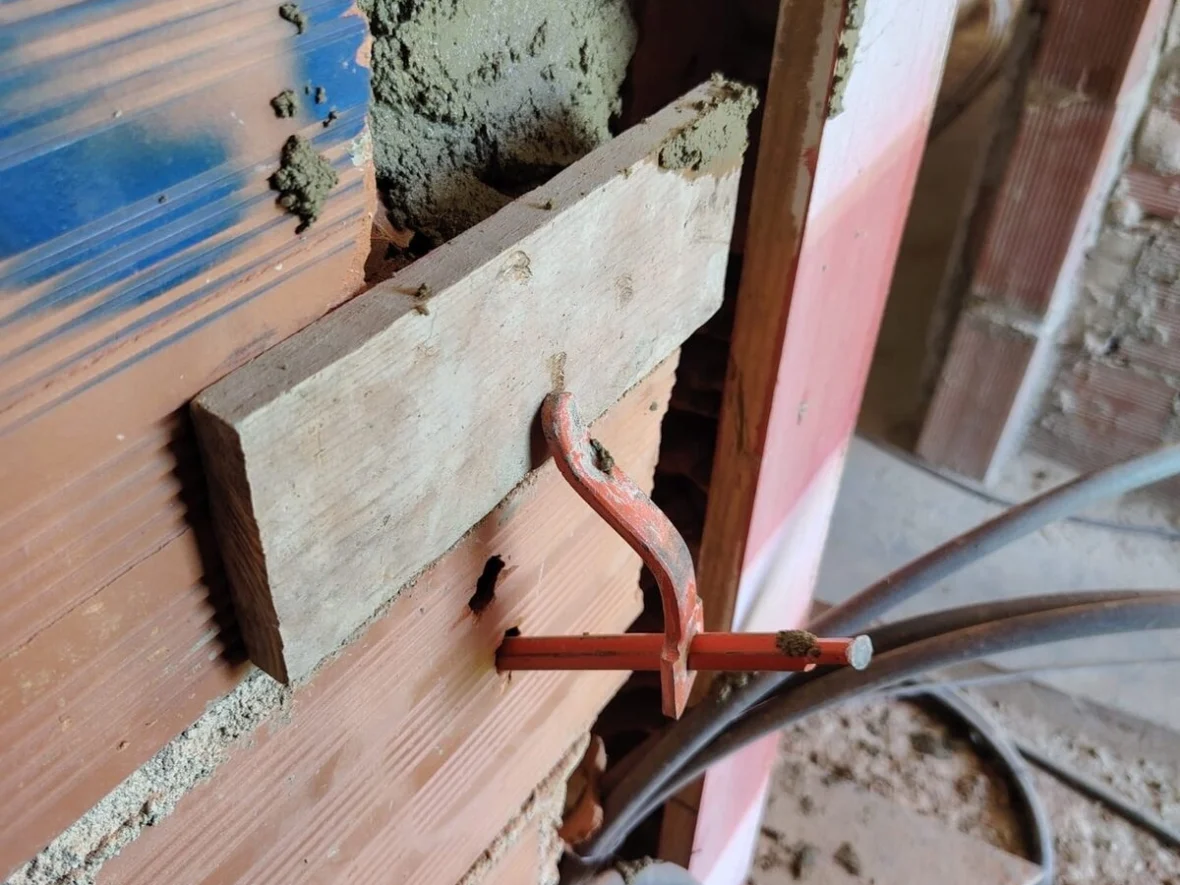 Cutting and running pipework through a brick wall