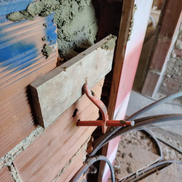 Cutting and running pipework through a brick wall