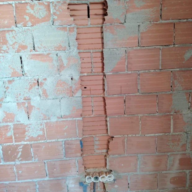 Vertical chase in a brick wall, made good